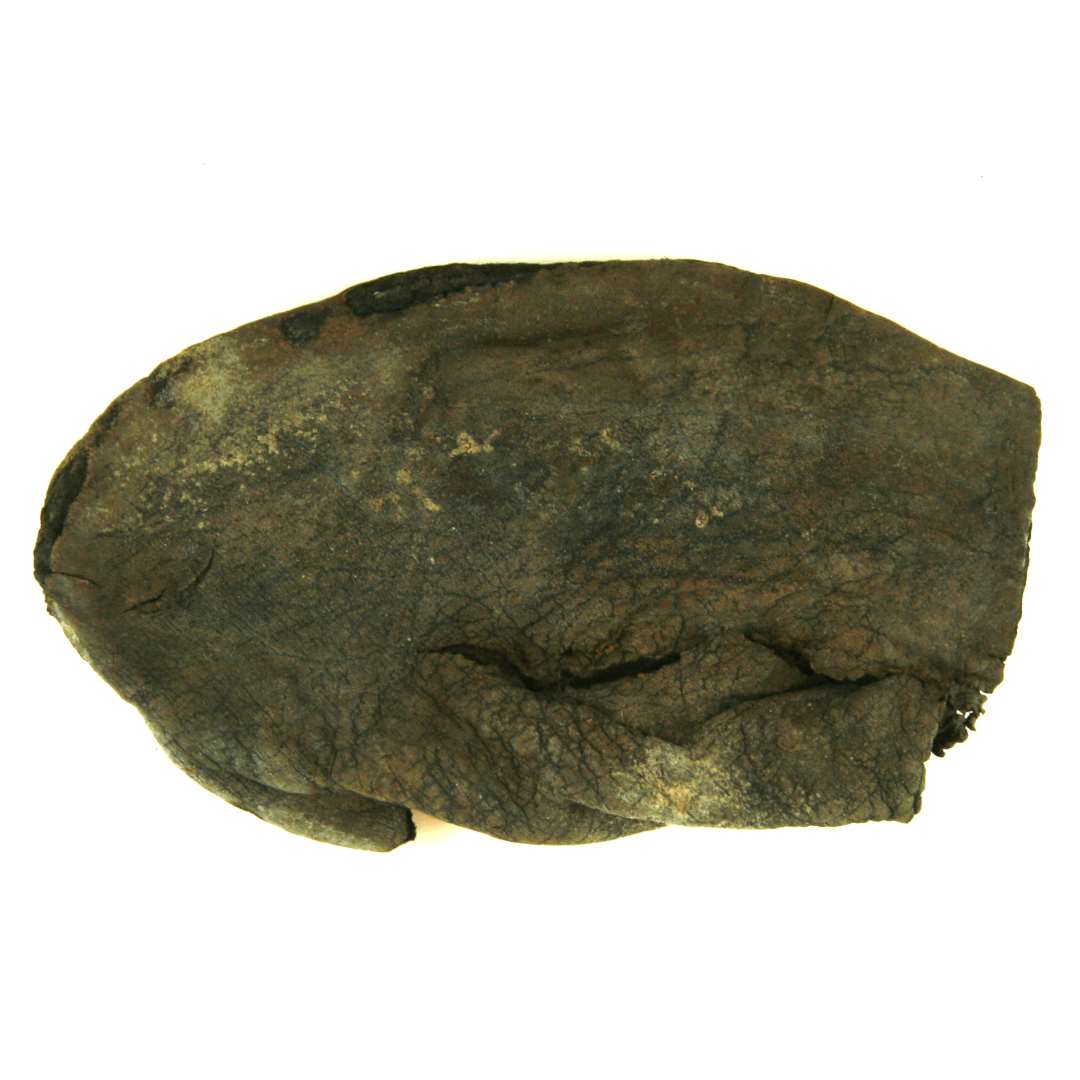 Fragment af overl�der fra st�vle med svagt tilspidset snude til voksen person. Fragmentet best�r af eet stykke l�der og hidr�rer fra st�vlens snude- og vristparti, hvor det er tilsk�ret i flad bueform. S�mhuller findes langs alle kanter. Temmelig defekt i vristpartiet. L�ngde fra snudespids til vristmidte: 16,5 cm. St�rste bredde over vrist: ca. 19 cm.