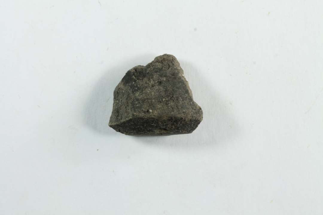 Fragment af tenv�gt af ler. Konisk med facet. St�rste m�l: 2,5 cm.